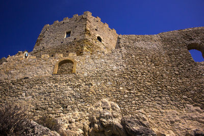 Low angle view of old medioeval castel in palma di montechiaro sicily against sky