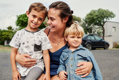 Cheerful mother with kids outdoors