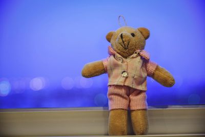 Close-up of stuffed toy against blue sky