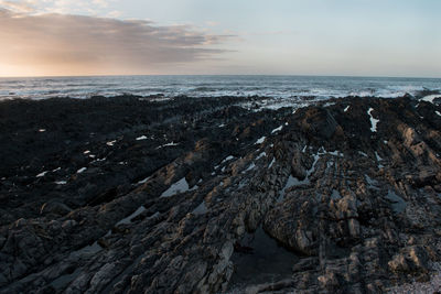 Scenic view of sea against sky at sunset