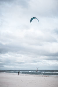 Man paragliding at beach