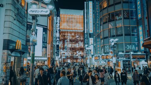 People on city street amidst buildings