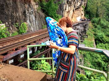 Low angle view of woman standing on railroad tracks