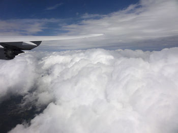 Aerial view of cloudscape over airplane wing