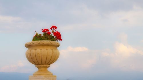 Close-up of red flower pot against sky