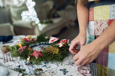 Midsection of woman with christmas tree