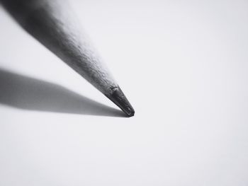 Close-up of cigarette over white background