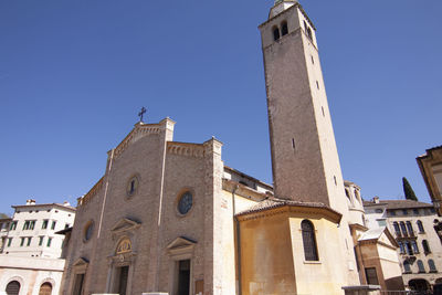 Low angle view of old building against clear blue sky