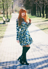 Full length of young woman against tree