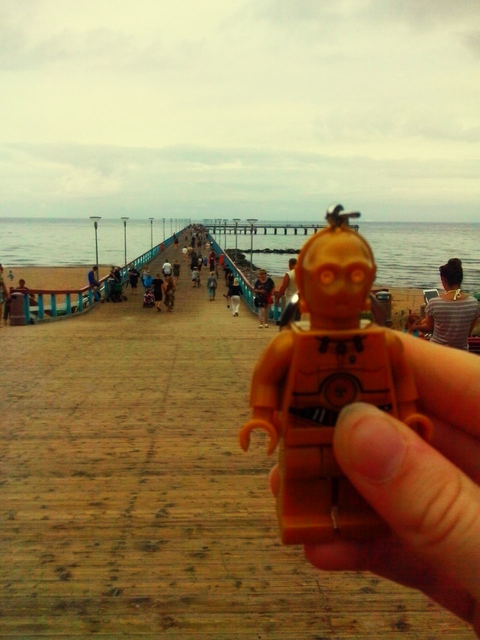 CLOSE-UP OF MAN HOLDING UMBRELLA ON BEACH