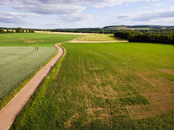 Scenic view of farm against sky