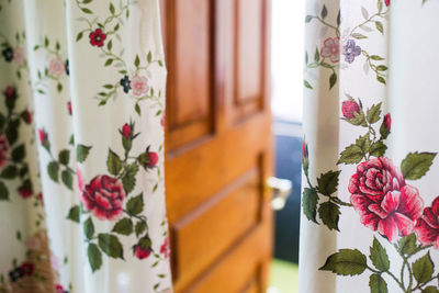 Curtains with flowers and a door. out of focus