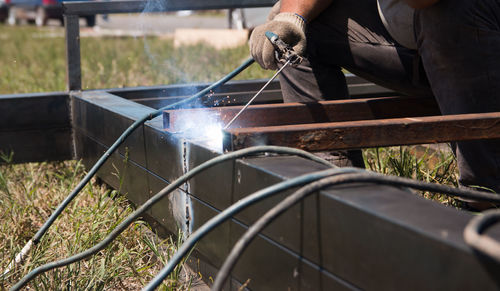 Midsection of welder welding metal