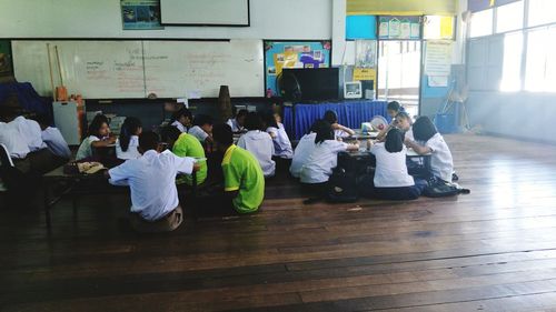 High angle view of people sitting on floor