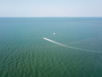 Aerial view parasailing activity at sea.