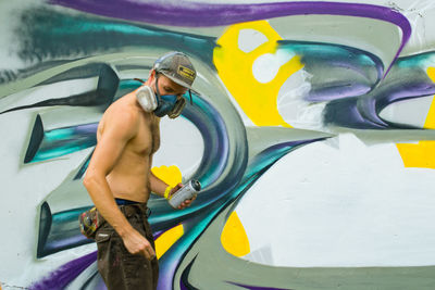 Man spray painting wall