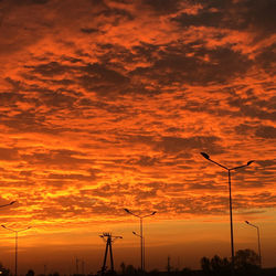 Silhouette street light against dramatic sky during sunset