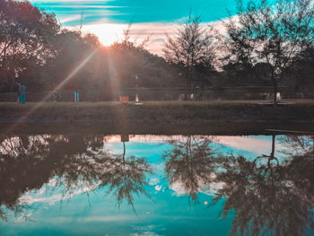 Swimming pool by lake against sky