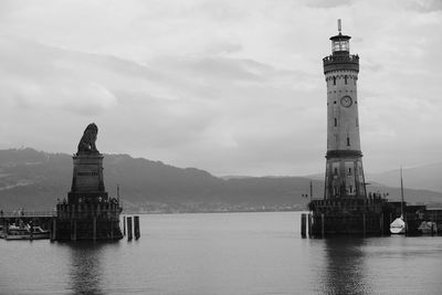 Lighthouse on building against cloudy sky