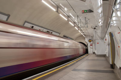 Blurred motion of train at railroad station