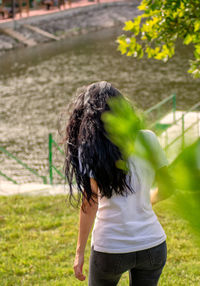 Rear view of woman standing on field