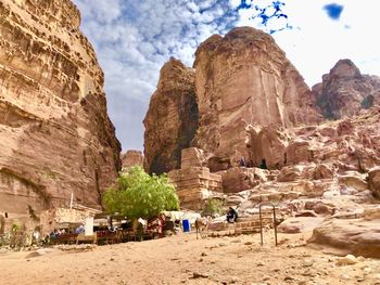 View of rock formations against cloudy sky