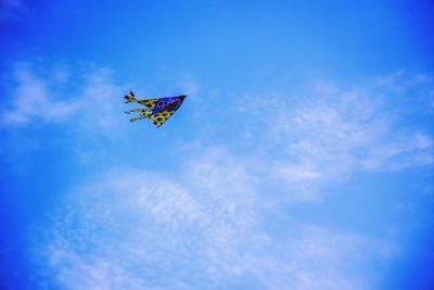 Low angle view of helicopter flying in sky