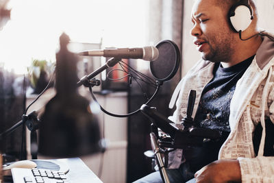 Disabled male singer recording music in studio