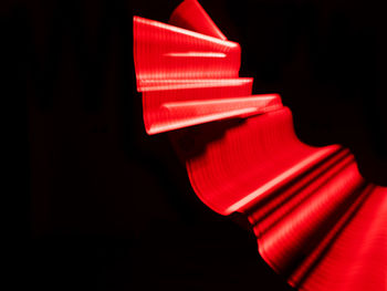 Close-up of illuminated light bulb against black background