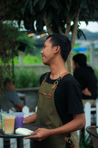 Side view of young man looking away