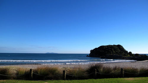 Scenic view of sea against clear blue sky