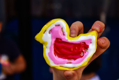 Close-up of hand holding ice cream