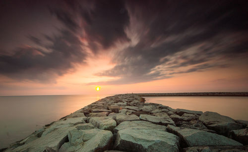 Scenic view of sea against dramatic sky