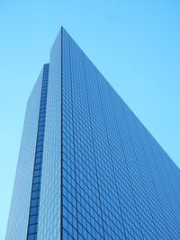 Low angle view of skyscraper against clear blue sky