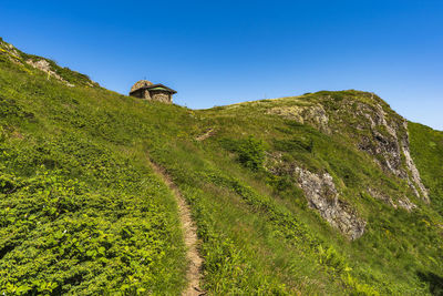 Scenic view of land against clear blue sky