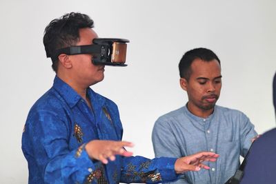 Young man using virtual reality simulator
