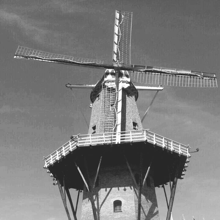 built structure, architecture, traditional windmill, renewable energy, building exterior, windmill, alternative energy, wind power, crane - construction machinery, wind turbine, low angle view, environmental conservation, sky, fuel and power generation, technology, crane, development, outdoors, day, construction site