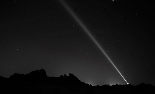 Low angle view of silhouette field against sky at night