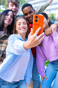 Portrait of young woman using mobile phone