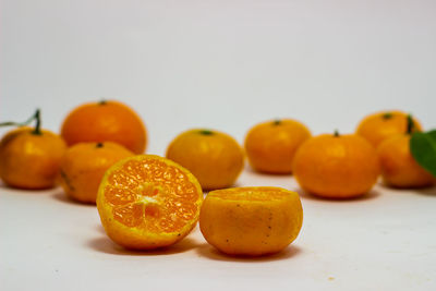 Close-up of fruits on table against white background