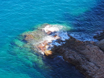 High angle view of rocky shore and sea