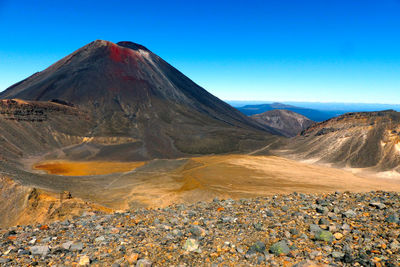 Scenic view of mountain range against blue sky