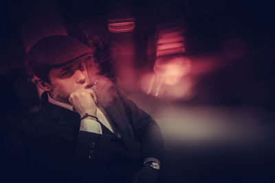 Young man smoking at night