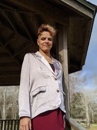 Low angle portrait of young woman standing at gazebo