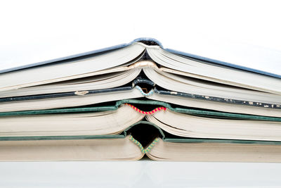 Close-up of books on table against white background