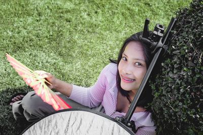 Portrait of a smiling young woman lying on grass