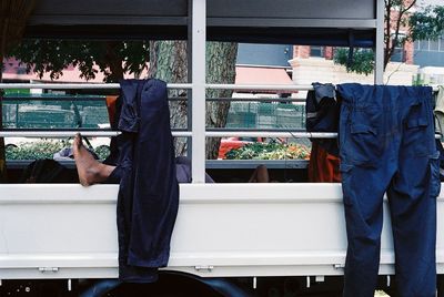 Cloths hanging on railing in garden