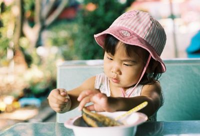 Cute girl having food at restaurant