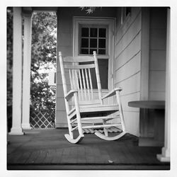 Empty chairs on porch of building