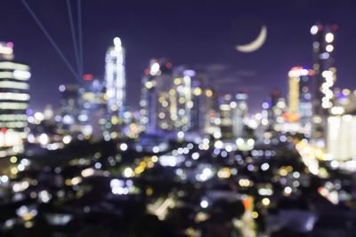 Defocused image of illuminated buildings at night